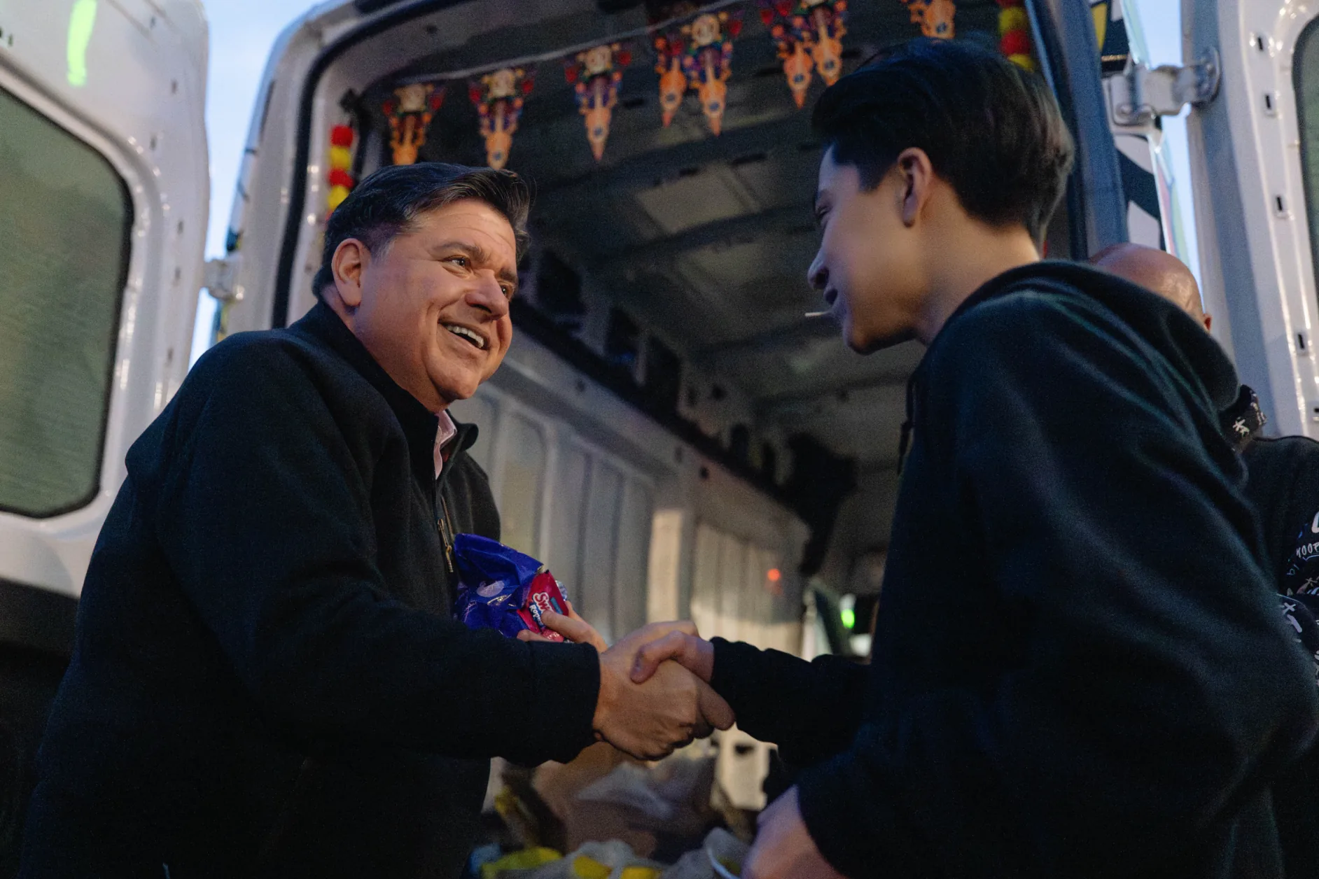 photo of Governor JB Pritzker shaking hands with constituent