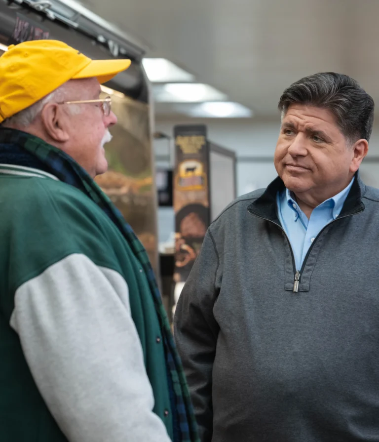 photo of Governor JB Pritzker speaking with constituent